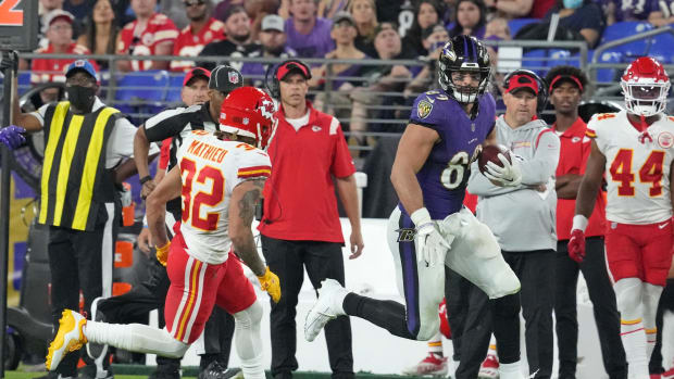 Baltimore Ravens tight end Mark Andrews (89) runs for a third quarter gain after his catch defended by Kansas City Chiefs safety Tyrann Mathieu (32) at M&T Bank Stadium. Mandatory Credit: Mitch Stringer-USA TODAY Sports