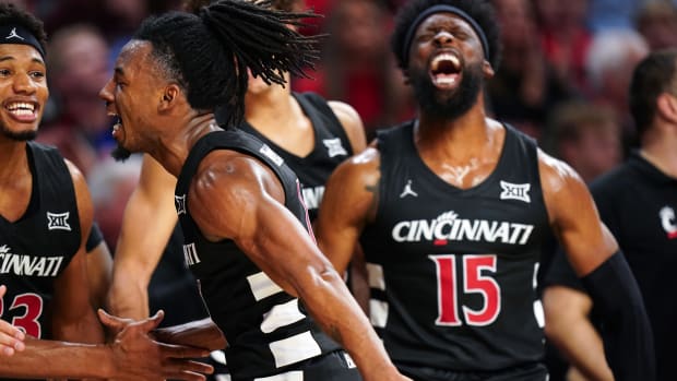 Cincinnati Bearcats guard Day Day Thomas (1) celebrates with the team on the bench in the second half during an NCAA college basketball game between Georgia Tech Yellow Jackets and the Cincinnati Bearcats, Wednesday, Nov. 22, 2023, at Fifth Third Arena in Cincinnati.