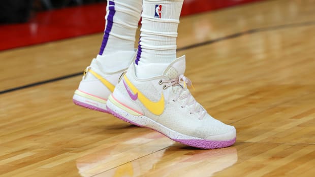 View of white, yellow, and purple Nike LeBron shoes.