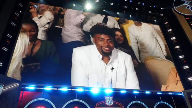 Arkansas wide receiver Treylon Burks reacts after being selected as the eighteenth overall pick to the Tennessee Titans during the first round of the 2022 NFL Draft at the NFL Draft Theater.