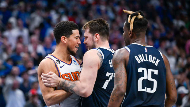Phoenix Suns guard Devin Booker argues with Dallas Mavericks guard Luka Doncic.