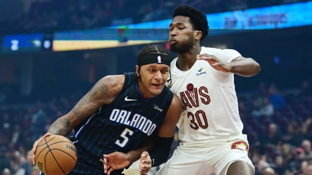 Oct 12, 2023; Cleveland, Ohio, USA; Orlando Magic forward Paolo Banchero (5) drives to the basket against Cleveland Cavaliers center Damian Jones (30) during the first quarter at Rocket Mortgage FieldHouse.