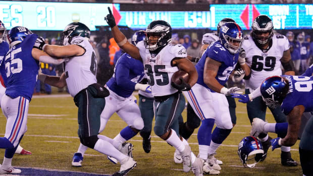Eagles running back Boston Scott scored three touchdowns to help clinch the NFC East title with win over the Giants