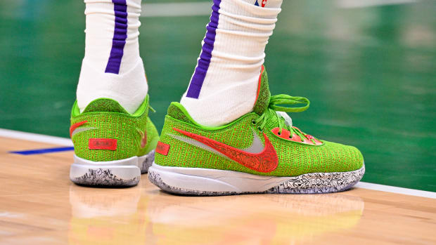 View of green and red Nike LeBron shoes.