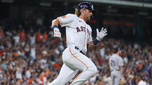 Jul 4, 2023; Houston, Texas, USA; Colorado Rockies starting pitcher Kyle Freeland (21) reacts and Houston Astros shortstop Grae Kessinger (16) runs to first base after hitting a home run during the third inning at Minute Maid Park. Mandatory Credit: Troy Taormina-USA TODAY Sports  