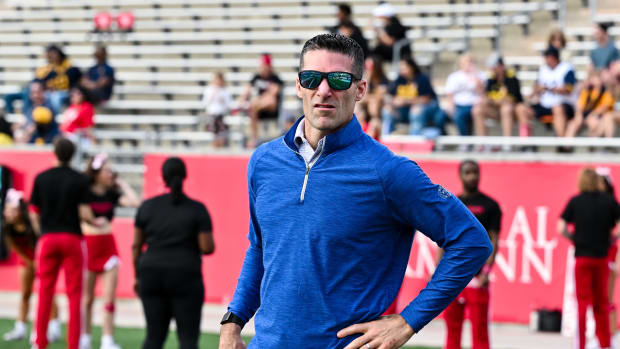 Texans general manager Nick Caserio walks on the sideline prior to the game between the Houston Cougars and the West Virginia Mountaineers at TDECU Stadium.