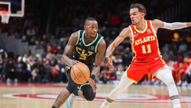 Hornets guard Terry Rozier dribbles past Hawks guard Trae Young.
