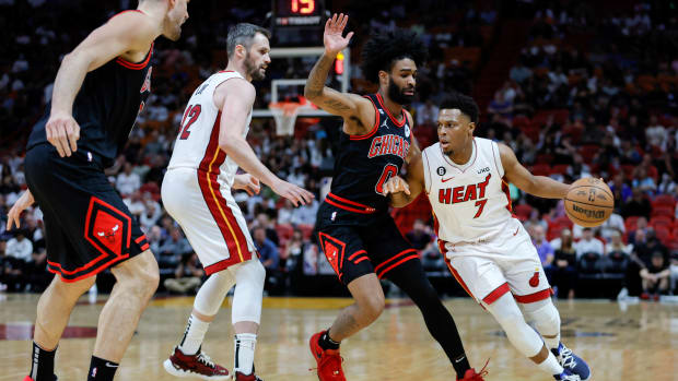 Apr 14, 2023; Miami, Florida, USA; Miami Heat guard Kyle Lowry (7) dribbles the basketball as Chicago Bulls guard Coby White (0) defends during the first quarter at Kaseya Center.
