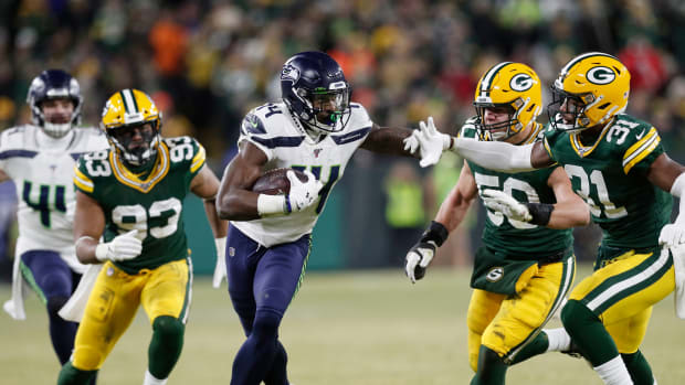 Seattle Seahawks wide receiver D.K. Metcalf (14) tries to get away from Green Bay Packers strong safety Adrian Amos (31) in the third quarter of a NFC Divisional Round playoff football game at Lambeau Field.