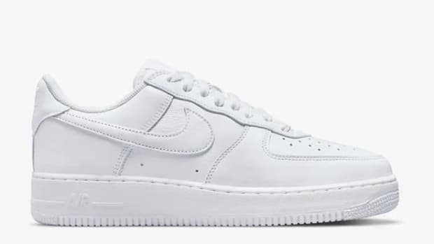 Side view of white Nike shoe.