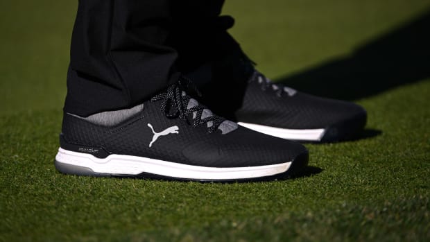 View of Rickie Fowler's black and white PUMA golf shoes.