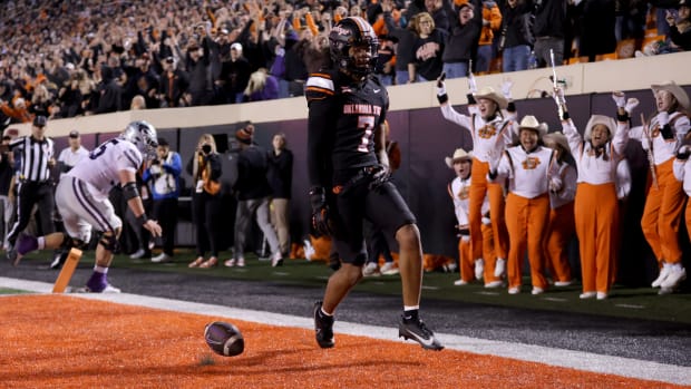 Oklahoma State's Cameron Epps (7) returns an interception for a touchdown in front of Kansas State's Hayden Gillum (55) in the first half of the college football game between the Oklahoma State University Cowboys and the Kansas State Wildcats at Boone Pickens Stadium in Stillwater. Okla., Friday, Oct. 6, 2023.