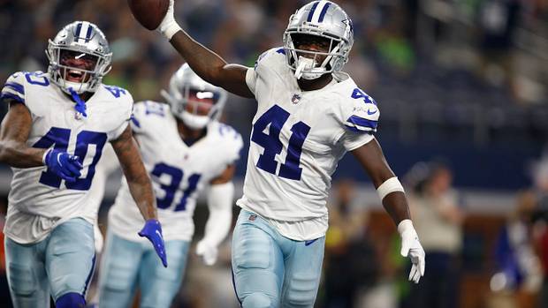 Markquese Bell celebrates a big play with his Cowboys teammates.