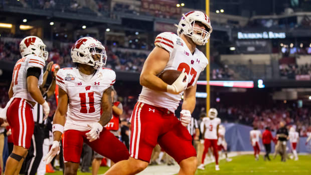Wisconsin tight end Hayden Rucci celebrates a touchdown reception against Oklahoma State in the Guaranteed Rate Bowl.
