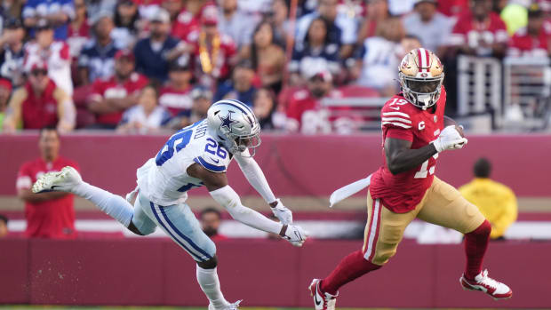 San Francisco 49ers wide receiver Deebo Samuel runs the football against Dallas Cowboys defense.