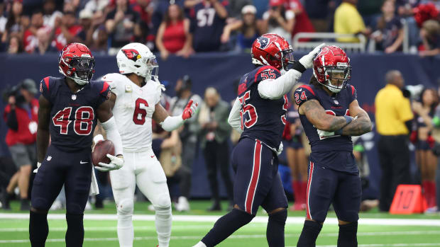 Texans cornerback Derek Stingley Jr. is congratulated with a tap on the helmet by defensive end Jerry Hughes after breaking up a pass intended for Arizona Cardinals running back James Conner
