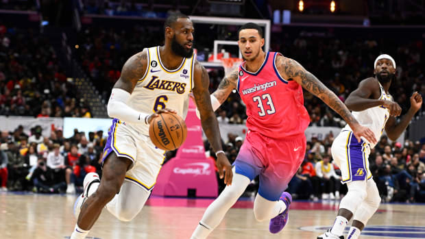 Los Angeles Lakers forward LeBron James (6) drives past Washington Wizards forward Kyle Kuzma (33) during the second half at Capital One Arena. Mandatory Credit: Brad Mills-USA TODAY Sports