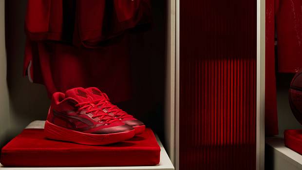 Side view of red Puma basketball shoes.