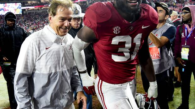 Crimson Tide head coach Nick Saban and linebacker Will Anderson Jr. (31) share a smile as they leave the field after defeating the Auburn Tigers at Bryant-Denny Stadium. Alabama won 49-27