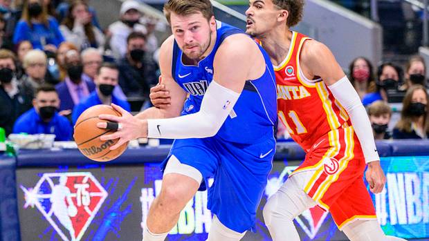 Hawks guard Trae Young defends Mavericks guard Luka Doncic.