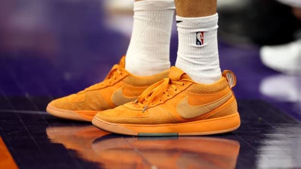 Phoenix Suns guard Devin Booker's orange Nike sneakers.