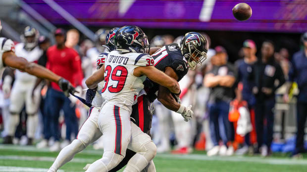 Oct 8, 2023; Atlanta, Georgia, USA; Houston Texans safety Grayland Arnold (25) and linebacker Henry To'oTo'o (39) cause Atlanta Falcons tight end Jonnu Smith (81) to fumble the ball recovery by the Texans at Mercedes-Benz Stadium. Mandatory Credit: Dale Zanine-USA TODAY Sports