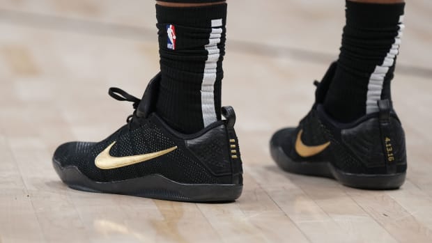 View of black and gold Nike Kobe shoes.