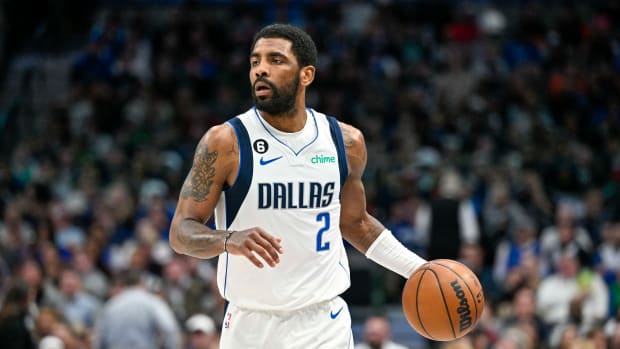 Dallas Mavericks guard Kyrie Irving dribbles the basketball up the court.