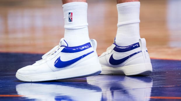 Phoenix Suns guard Devin Booker's white and purple Nike sneakers.