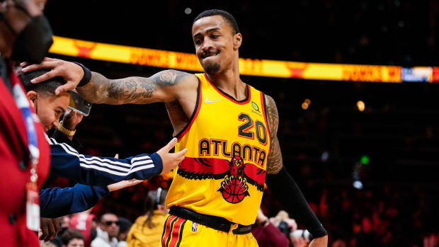 Atlanta Hawks forward John Collins (20) reacts with Trae Young s brother Tim after the Hawks defeated the Los Angeles Lakers at State Farm Arena.