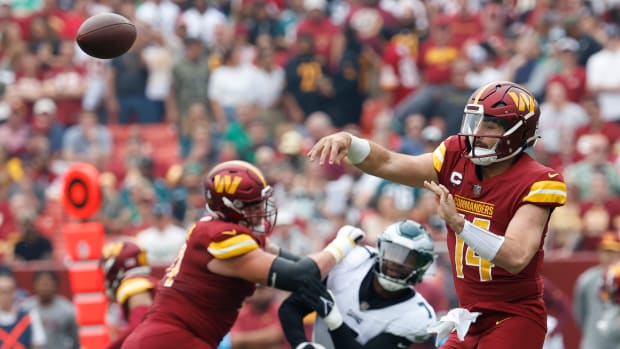 Washington Commanders quarterback Sam Howell (14) passes the ball against the Philadelphia Eagles during the first quarter at FedExField.
