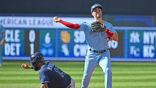 Sep 30, 2023; Toronto, Ontario, CAN; Toronto Blue Jays second baseman Whit Merrifield (15) throws to first base to complete a double play after forcing out Tampa Bay Rays center Manuel Margot (13) in the second inning at Rogers Centre. Mandatory Credit: Dan Hamilton-USA TODAY Sports  