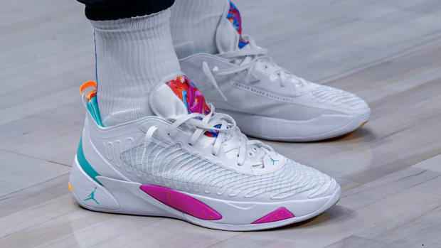 View of white and pink Jordan Luak shoes.