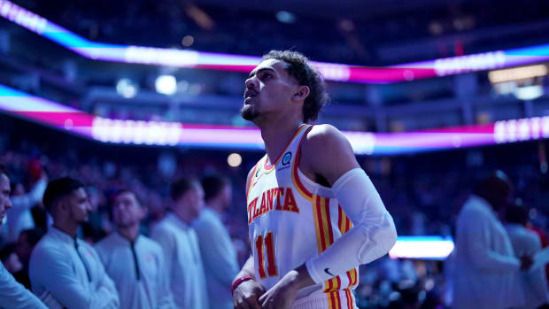 Hawks guard Trae Young stands on the court before a game.