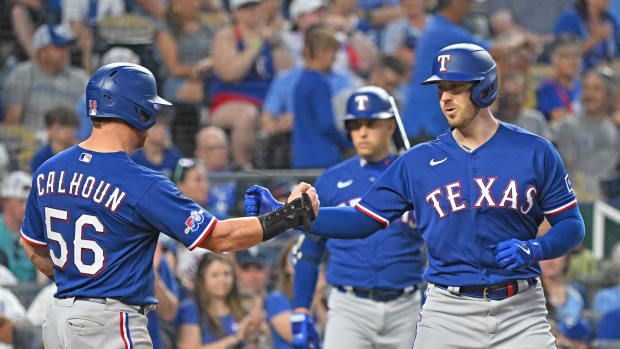 Jun 27, 2022; Kansas City, Missouri, USA; Texas Rangers designated hitter Mitch Garver (18) celebrates with outfielder Kole Calhoun (56) after hitting a two run home run during the fifth inning against the Kansas City Royals at Kauffman Stadium. Mandatory Credit: Peter Aiken-USA TODAY Sports