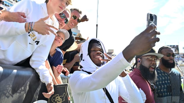 Sep 30, 2023; Boulder, Colorado, USA; Colorado Buffaloes cornerback Travis Hunter (12) takes selfies with fans after the game against the USC Trojans at Folsom Field. Mandatory Credit: John Leyba-USA TODAY Sports  