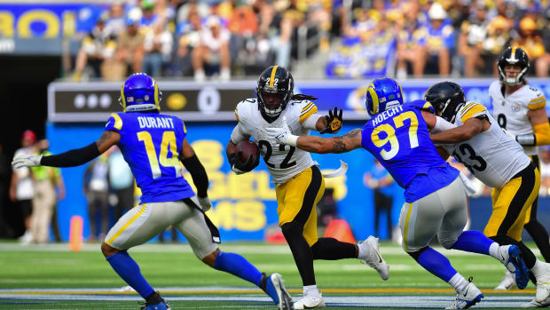 Pittsburgh Steelers running back Najee Harris (22) runs the ball against Los Angeles Rams linebacker Michael Hoecht (97) and cornerback Cobie Durant (14) during the first half at SoFi Stadium.
