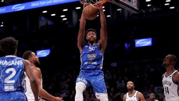 Oct 12, 2023; Brooklyn, NY, USA; Maccabi Ra'anana forward Bruno Caboclo (50) dunks against Brooklyn Nets guard Ben Simmons (10) and forwards Mikal Bridges (1) and Harry Giles III (14) during the second quarter at Barclays Center.
