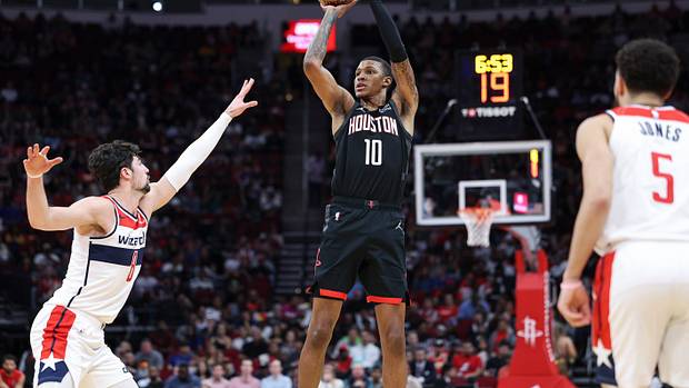 Rockets forward Jabari Smith Jr. (10) shoots the ball as Washington Wizards forward Deni Avdija (8) defends during the second quarter at Toyota Center.