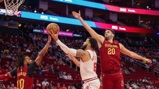 Mar 16, 2024; Houston, Texas, USA; Houston Rockets guard Fred VanVleet (5) splits the defense of Cleveland Cavaliers guard Darius Garland (10) and forward Georges Niang (20) in the first quarter at Toyota Center. Mandatory Credit: Thomas Shea-USA TODAY Sports