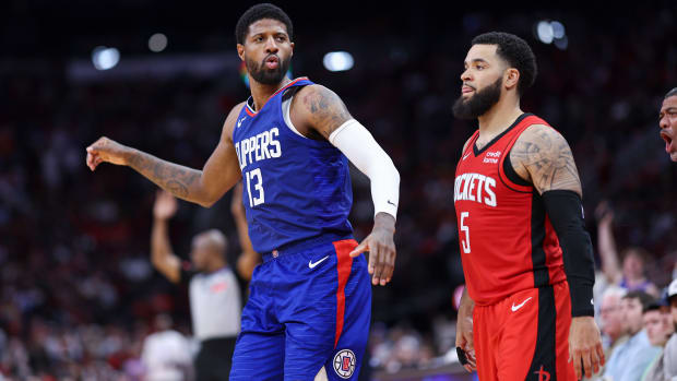 Clippers forward Paul George (13) reacts after making a basket as Houston Rockets guard Fred VanVleet (5) looks on during the fourth quarter at Toyota Center.