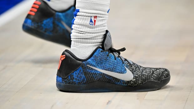 View of black and blue Nike Kobe shoes.