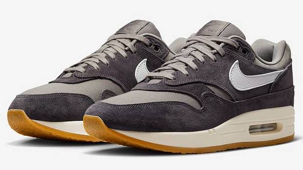 View of grey and tan Nike Air Max shoes.