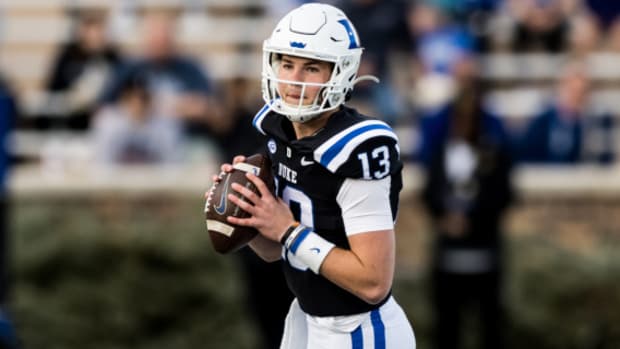 Duke Blue Devils quarterback Riley Leonard drops back for a pass during a college football game in the ACC.