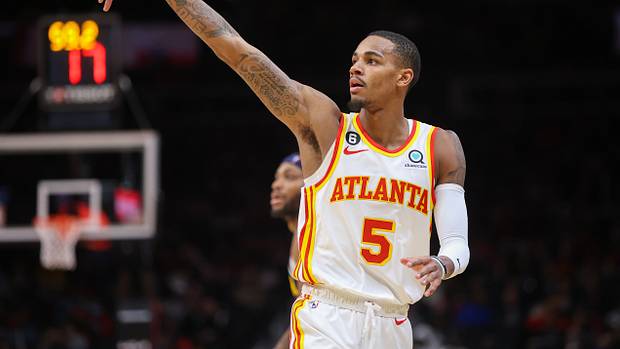 Hawks guard Dejounte Murray holds his form after making a shot.