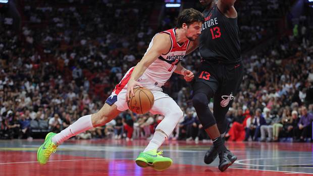 Washington Wizards forward Deni Avdija (8) drives to the basket against Miami Heat center Bam Adebayo (13) during the second quarter at Kaseya Center.