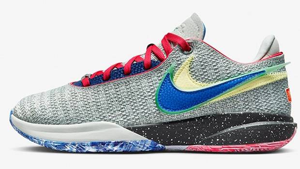 Side view of a grey and blue Nike LeBron basketball shoe.