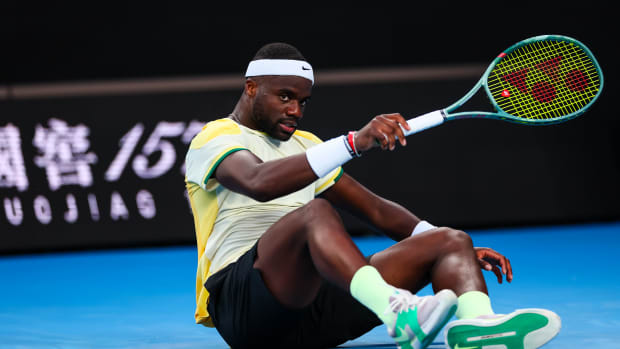 Frances Tiafoe falls on the court during the 2024 Australian Open.
