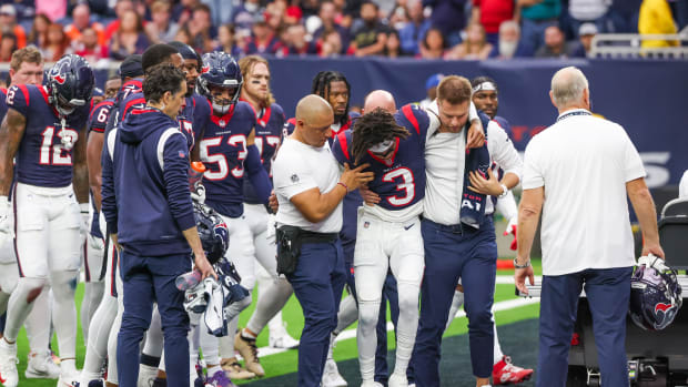 Trainers move an injured Houston Texans wide receiver Tank Dell to the cart as he injured himself on a touchdown play against the Denver Broncos at NRG Stadium