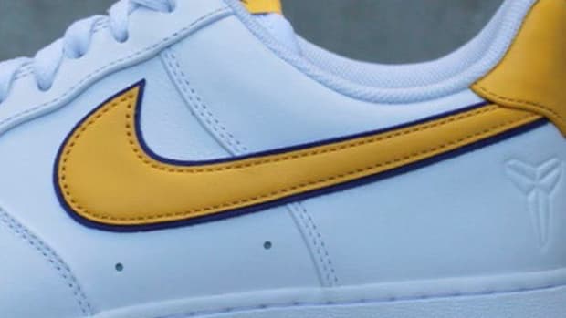 Side view of a white and gold Nike Air Force 1.